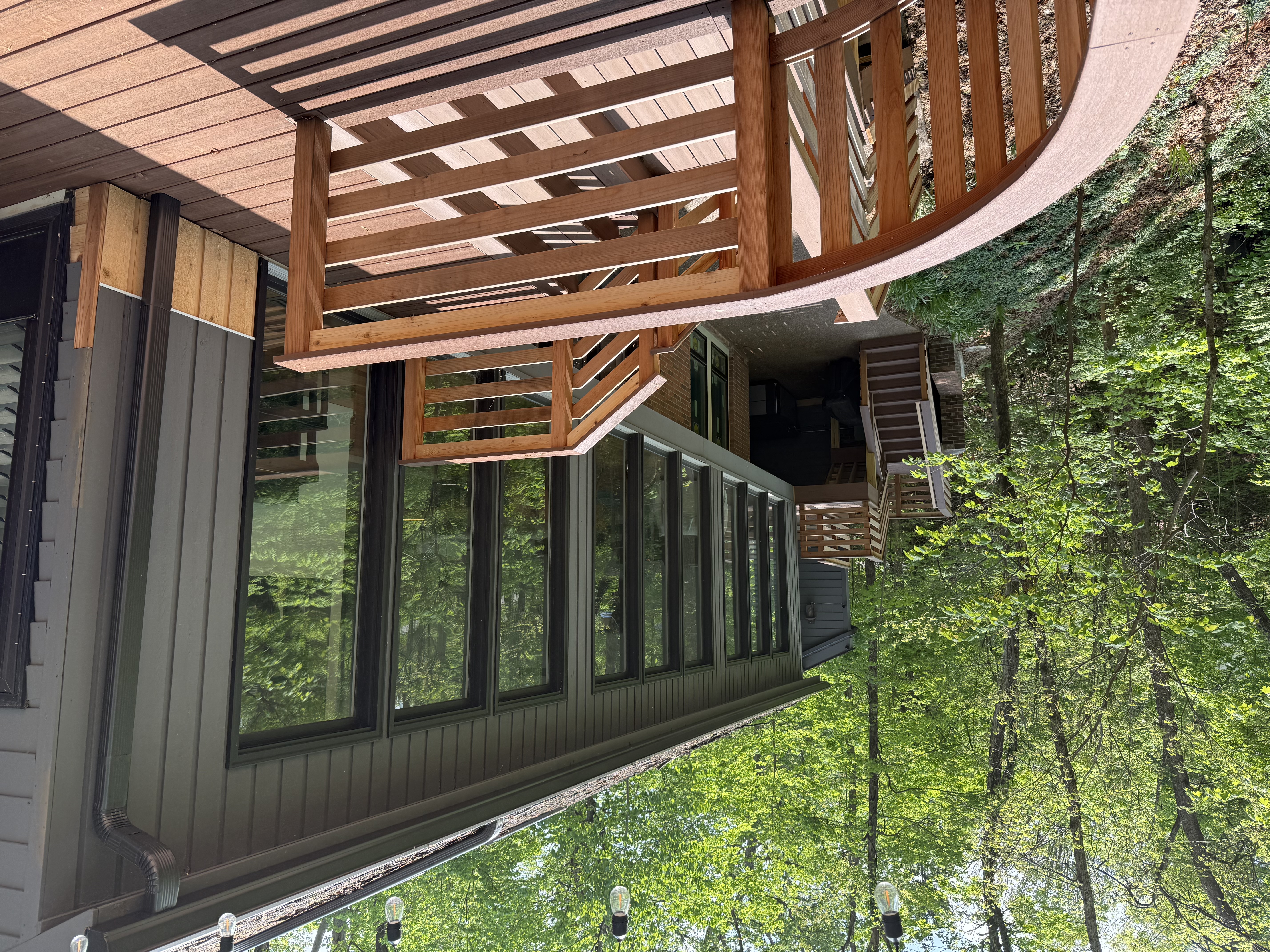 Back decks and patio with a view of the forest
